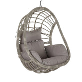 Aurora Nest szürke színű műrattan kerti függőfotel bézs párnákkal, fehér háttér előtt, oldalnézetből.