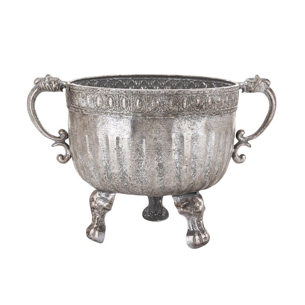 Ezüstszínű, dombormintával díszített, lábakon álló fém kaspótál.