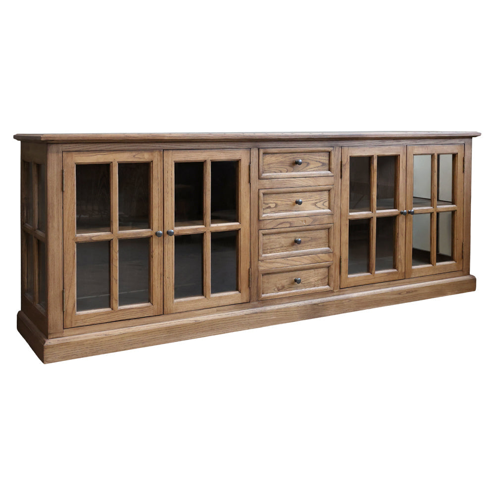 Natúr színű, 4 ajtós és 4 fiókos vitrines komódszekrény.