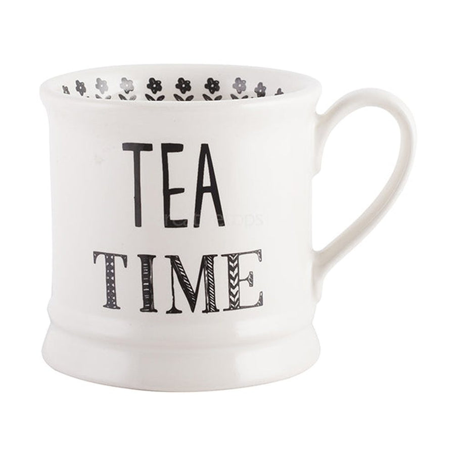 White ceramic mug from the Stir it Up collection with black flower motifs and the Tea Time inscription.