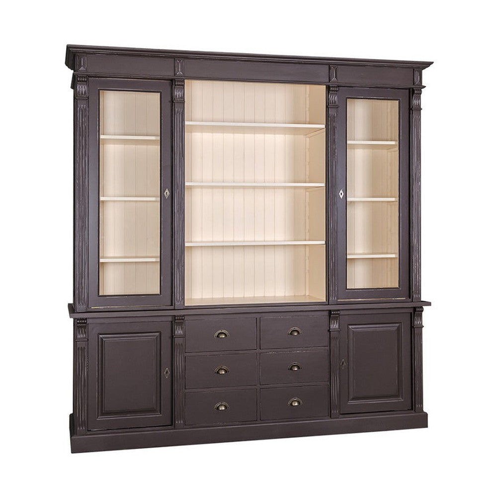 Sötétbarna és krémszínű, klasszikus stílusú könyvszekrény háromszor három polccal, melyek közül hatot üveges ajtó véd. Alul hat fiók és két ajtóval zárható tároló lett kialakítva.