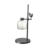 Loft stílusú,, madárral díszített, fém lombikállványba helyezett üveg váza.