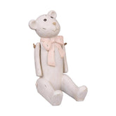 Vintage stílusú, enyhén kopott, antik krém színű, ülő helyzetű nosztalgikus maci figura, púderrózsaszín színű masnival a nyakában