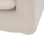 Bézs színű pamutvászon kárpitozású, kényelmes párnákkal ellátott kortárs kanapé.