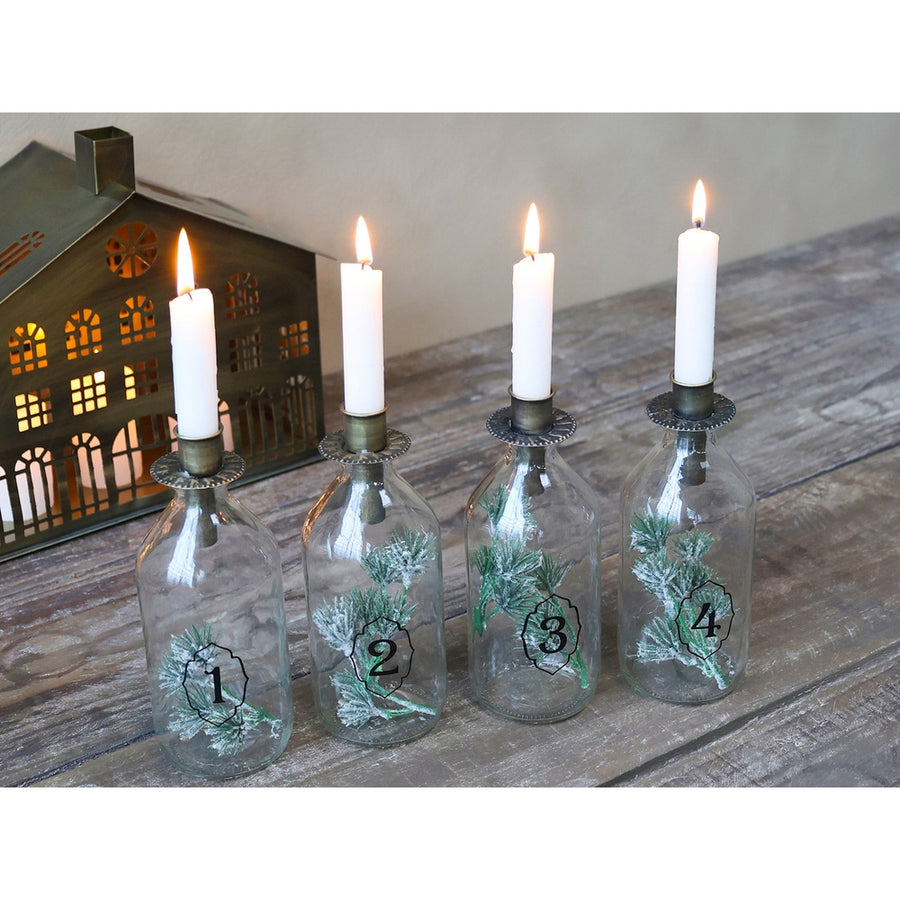 4 darabos, számozott díszítésű üvegpalackba kialakított adventi gyertyatartó szett.