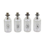 4 darabos, számozott díszítésű üvegpalackba kialakított adventi gyertyatartó szett.