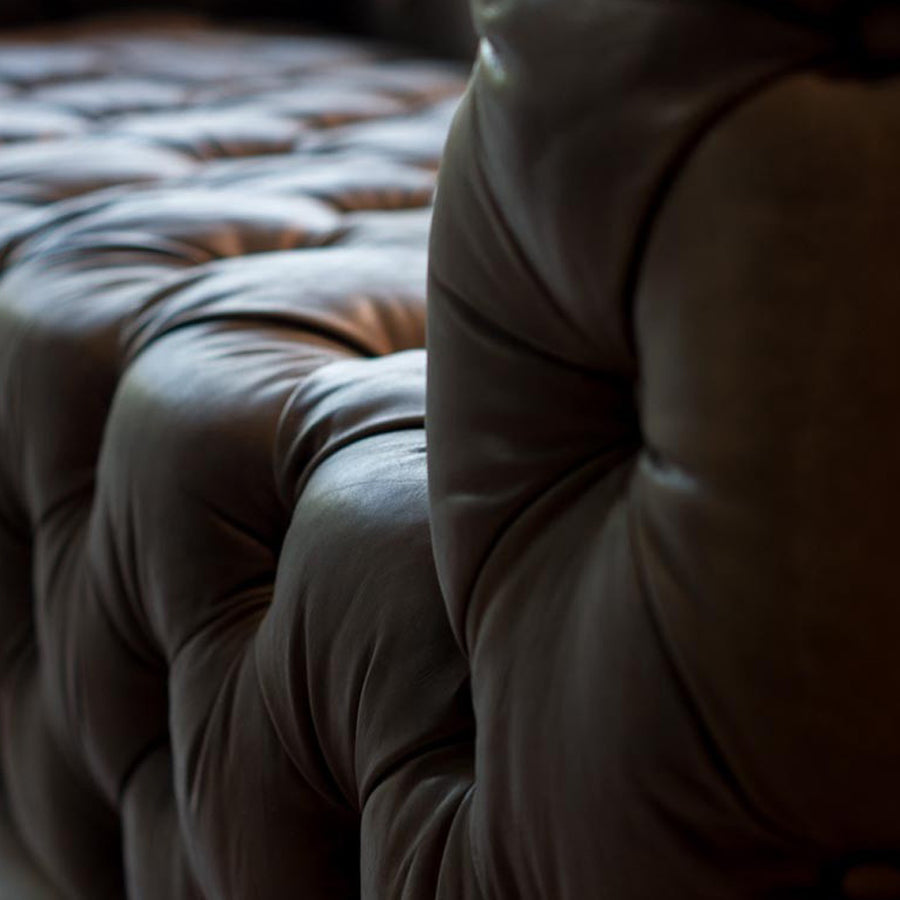 Szegecselt alumínium lemez borítású, montaigne fekete színű kecskebőrrel kárpitozott design kanapé.