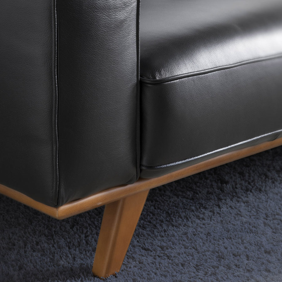 Kortárs stílusú, fekete bőrrel kárpitozott, dizájn fotel diófa lábakkal.