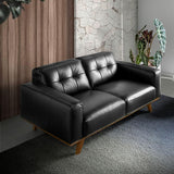 Fekete design kanapé modern nappali enteriőrben