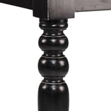 Esztergált fekete asztalláb – koloniál stílusú díszítéssel, közelről