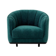 Tengerzöld színű szövettel kárpitozott dizájn fotel.