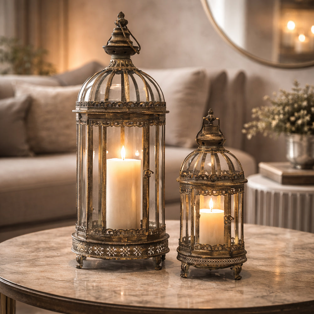 Antique Metals aranyszínű fém lámpás szett égő gyertyával elegáns nappali enteriőrben, márvány asztalon