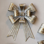 Rézszínű, fémből készült karácsonyi dekor masni.