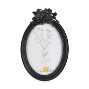 Fekete színű, ovális formájú&nbsp;fényképtartó.