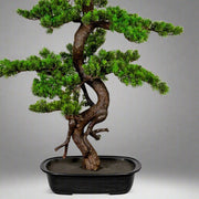 Zöld színű, mű mirtusz bonsai fa, fekete ovális műanyagkaspóban.