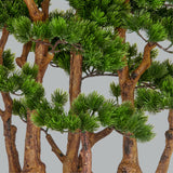 Zöld színű, mű fenyő bonsai fa, fekete színű műanyag cserépbe.