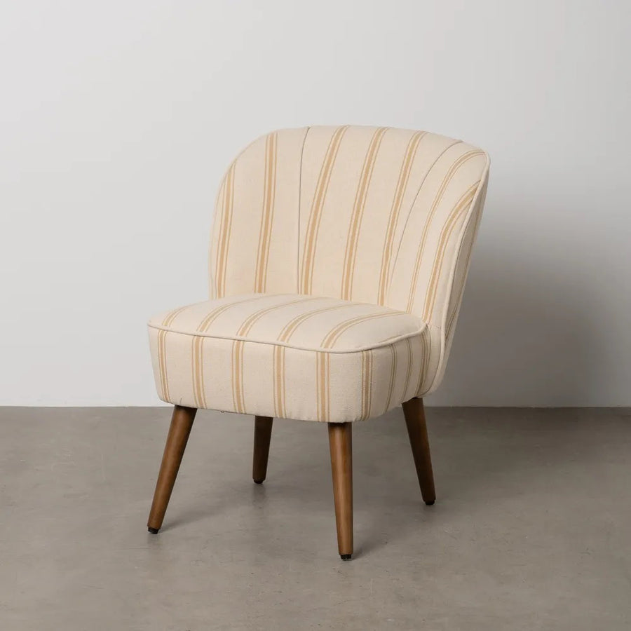 CLUB EMMA fotel okker-fehér csíkozással, betonpadlón, minimalista környezetben.