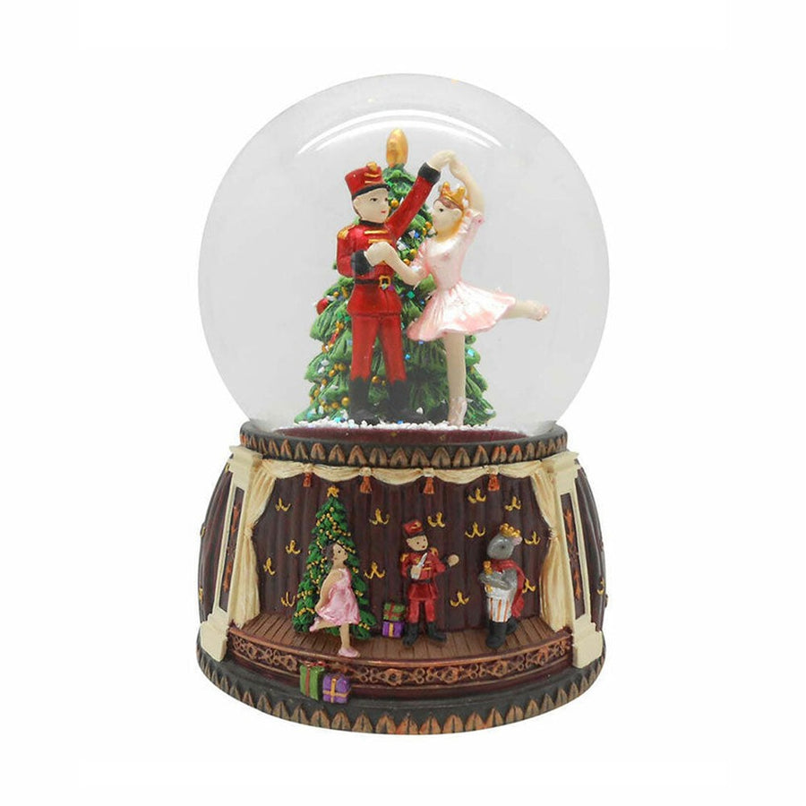 Karácsonyi zenélő-forgó hógömb, diótörővel és balerinával.