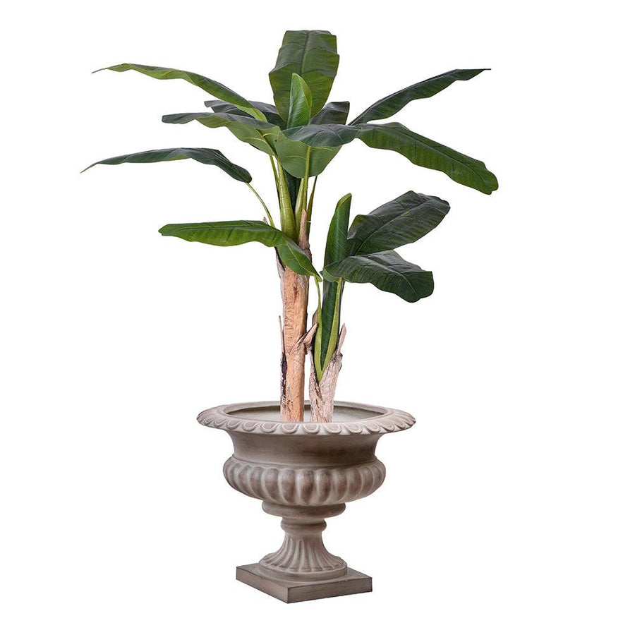 Antikolt homokszínű kaspó egzotikus növénnyel dekorálva, modern enteriőrbe illesztve