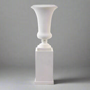 Fehér óriás kaspó elegáns posztamens talapzaton, stúdiófotón, semleges szürke háttérrel.