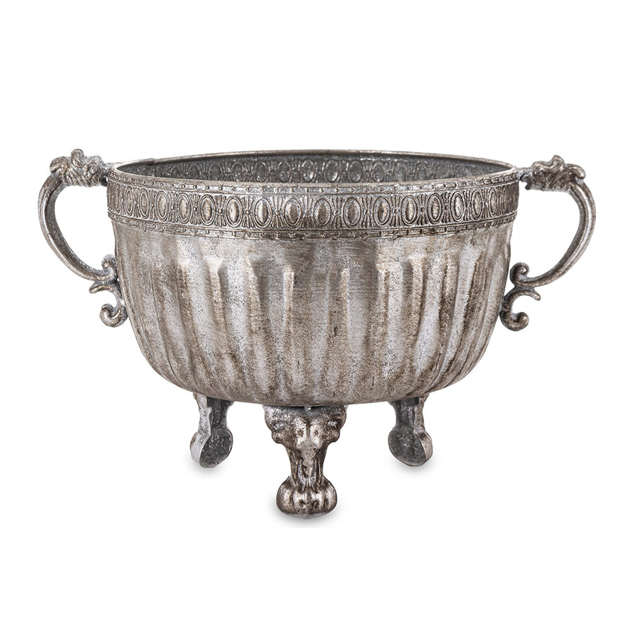 Ezüstszínű, dombormintával díszített, lábakon álló fém kaspó tál.