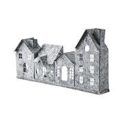 Szürke színű, bádogból készült házikókat formázó lámpás.