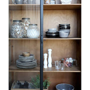 Fenyőfából készült, antik fekete színű 2 ajtós, 2 fiókos vitrines szekrény.