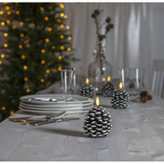 Havas fenyőtoboz formájú LED gyertya.