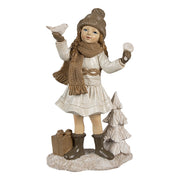 Tradicionális megjelenésű, madárkát tartó, bézs színű karácsonyi kislány.