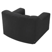 Fekete színű buklé szövettel kárpitozott dizájn fotel.