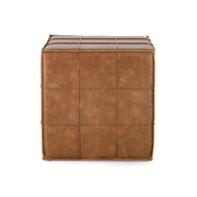 Konyakszínű műbőrrel kárpitozott puff.