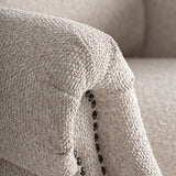 Krémszínű kárpit és szegecselt részlet közelről