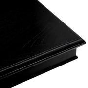 Fekete színű mindifa furnérból készült, formatervezett központi könyvtár asztal.