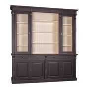 Fekete könyvszekrény bézs belső térrel, három üvegezett szekcióval és fiókos alsó résszel.