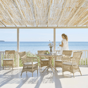 Vintage stílusú, natúr színű, műrattan kerti karosszék.