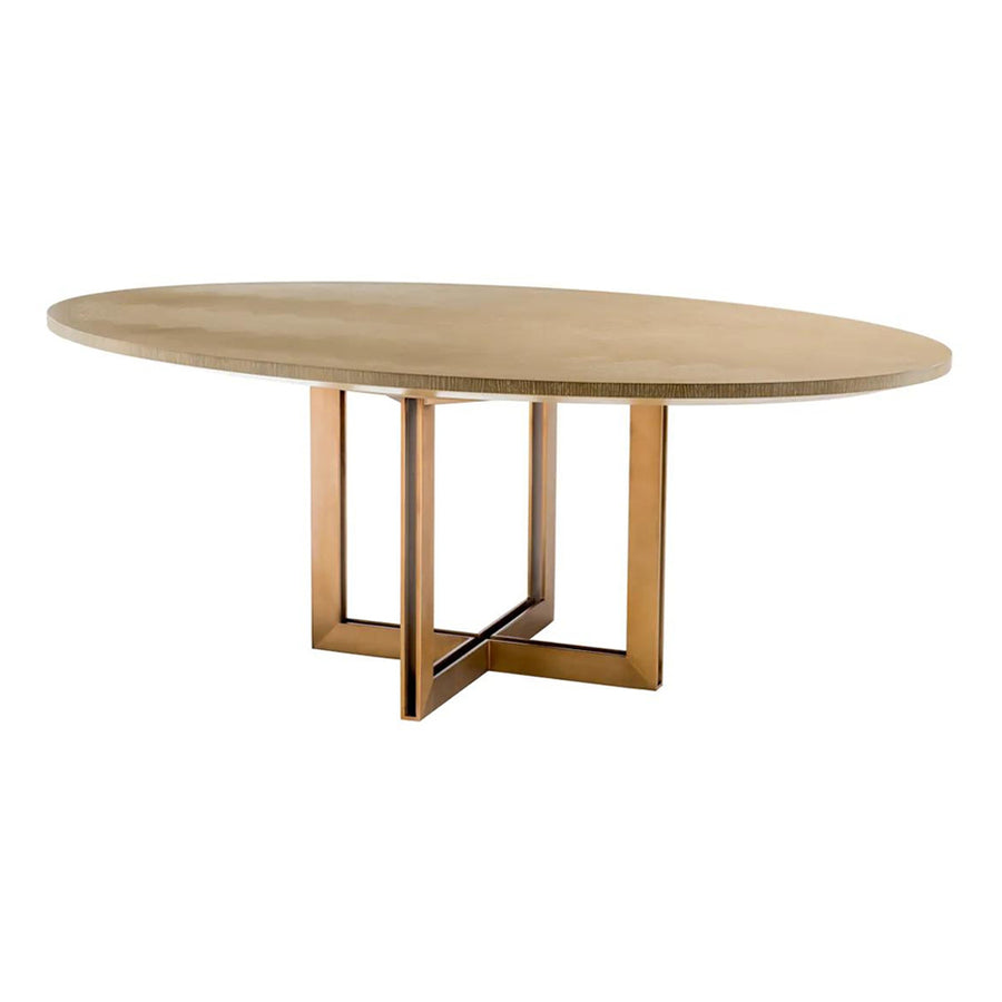 Natúrszínű tölgyfurnérból és sárgaréz felületű rozsdamentes acélból készült, ovális formájú design étkezőasztal.