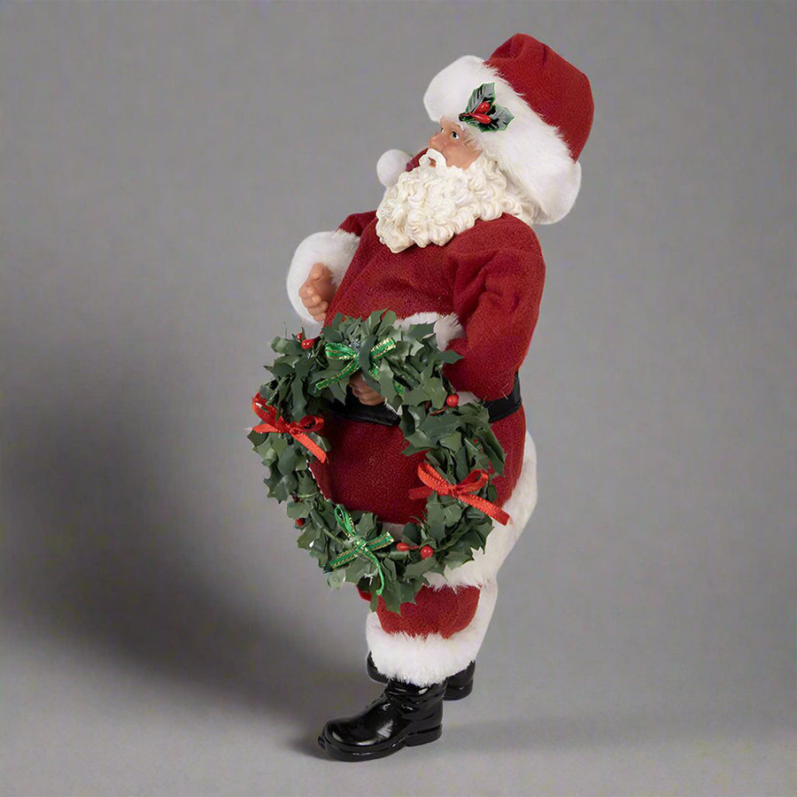 Koszorút tartó, piros színű Mikulás figura.