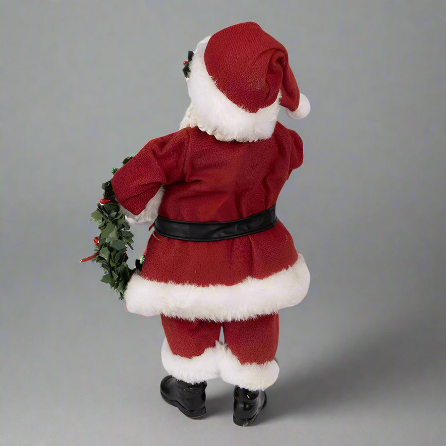 Koszorút tartó, piros színű Mikulás figura.