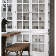 Fehér színű, 8 ajtós vitrines szekrény.