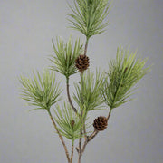 Tobozokkal díszített zöld színű, mű feketefenyő ág .