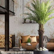 Élethű mű dicksonia páfrányfa nappali enteriőrben, szürke kaspóban, fehér dekorációs kövekkel