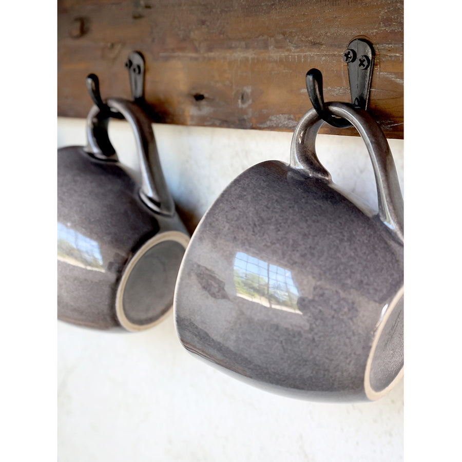 Kampókon függő szürke bögrék.