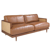 Barna színű marhabőrrel kárpitozott, rattanbetétes, 3 személyes design kanapé.