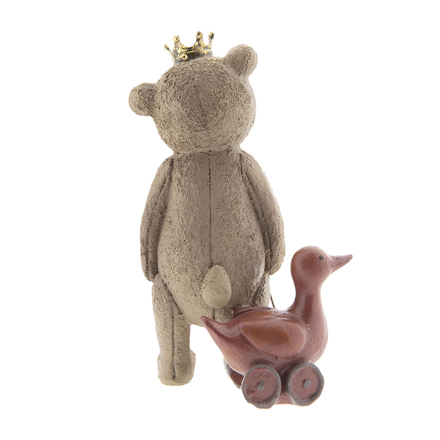 Játék libát húzó, koronát viselő nosztalgikus maci figura.