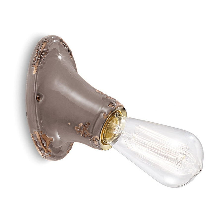 Antikolt felületű mázas kerámiából készült kézműves falilámpa.