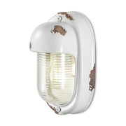 Antikolt felületű mázas kerámiából és bordázott üvegből készült kézműves falilámpa.