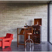 Kortárs stílus nappaliban felállított utazóláda bárszekrény italokkal és poharakkal.