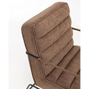 Barna színű velúr műbőrrel kárpitozott kortárs stílusú fotel.