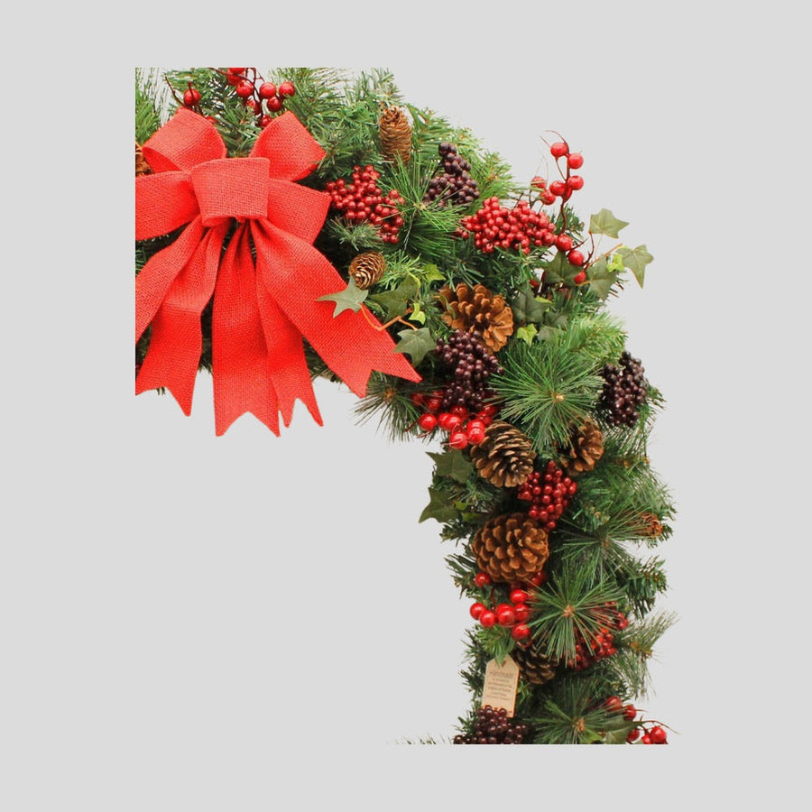 Vidéki stílusú, 180 cm hosszú karácsonyi fenyőgirland piros bogyókkal.