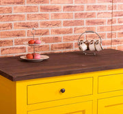 Tömör fenyőfa konyhaszekrény két fiókkal, polcos tárólóval. Színe: sárga bútor, sötétbarna munkafelület.